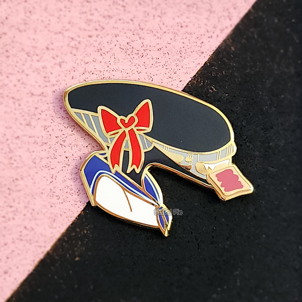 photo of an enamel pin by pistol pie of a kawaii xenomorph alien school girl with toast in her mouth
